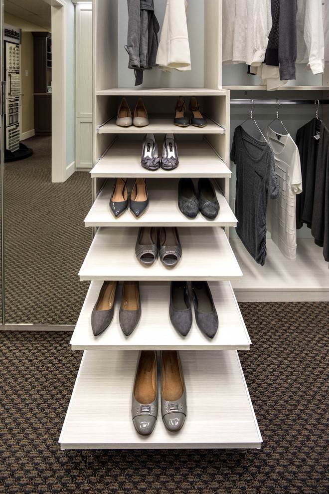 This is an example of a large contemporary gender neutral walk-in wardrobe in San Francisco with shaker cabinets, light wood cabinets and carpet.