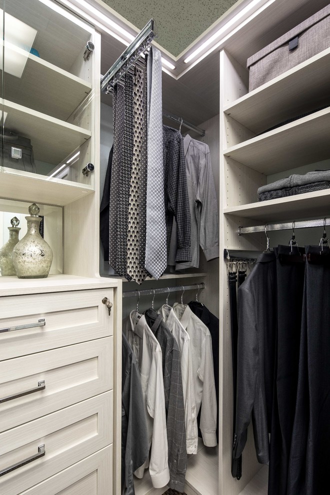 Large contemporary gender neutral walk-in wardrobe in San Francisco with shaker cabinets, light wood cabinets and carpet.