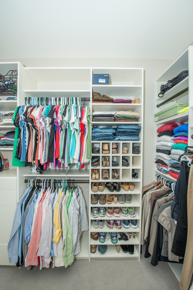 Inspiration for a large timeless gender-neutral carpeted and gray floor walk-in closet remodel in Other with open cabinets and white cabinets