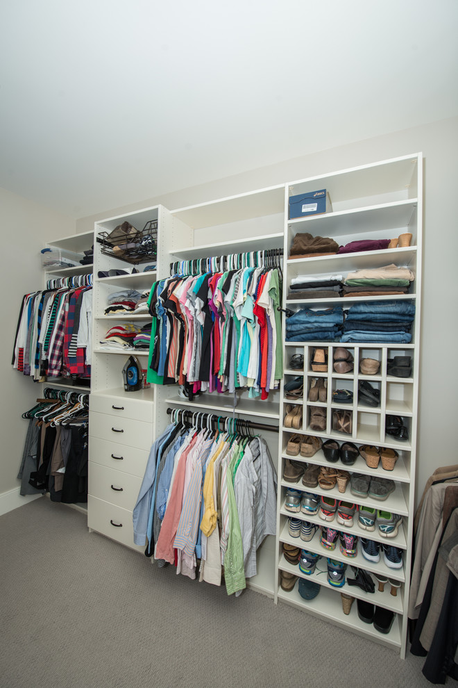 Photo of a large traditional gender neutral walk-in wardrobe in Other with open cabinets, white cabinets, carpet and grey floors.