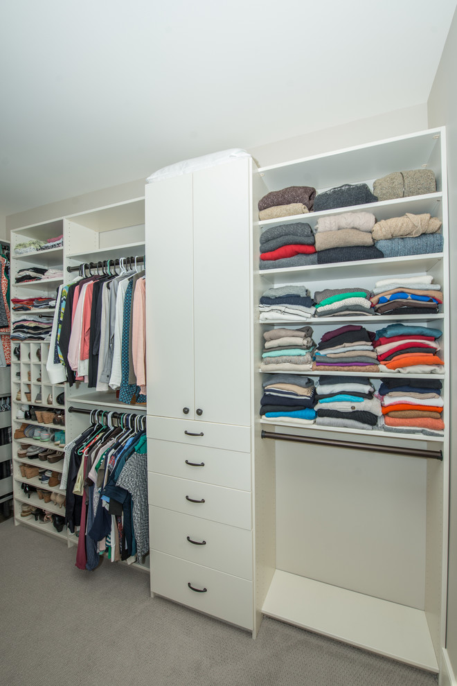 Large traditional gender neutral walk-in wardrobe in Other with open cabinets, white cabinets, carpet and grey floors.