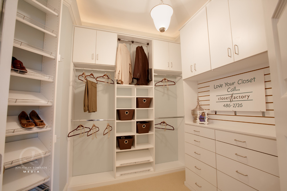 Design ideas for a large gender neutral walk-in wardrobe in Other with flat-panel cabinets, white cabinets and carpet.