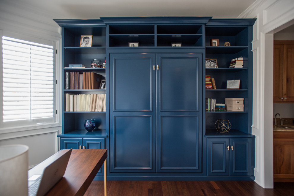 Example of a mid-sized transitional gender-neutral laminate floor and brown floor built-in closet design in Denver with recessed-panel cabinets and blue cabinets