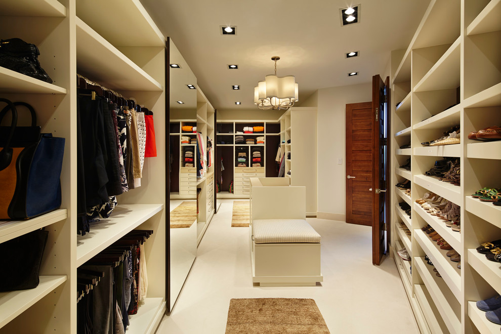 Expansive contemporary walk-in wardrobe in Miami with limestone flooring.