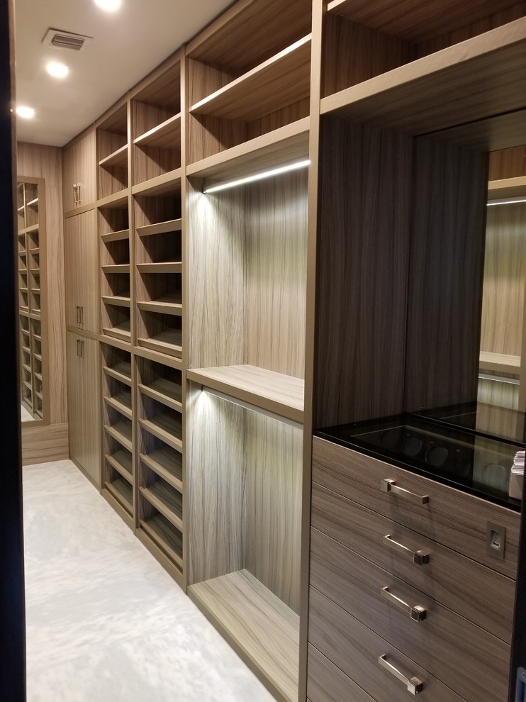 Example of a large transitional gender-neutral marble floor and white floor walk-in closet design in Miami with open cabinets and light wood cabinets