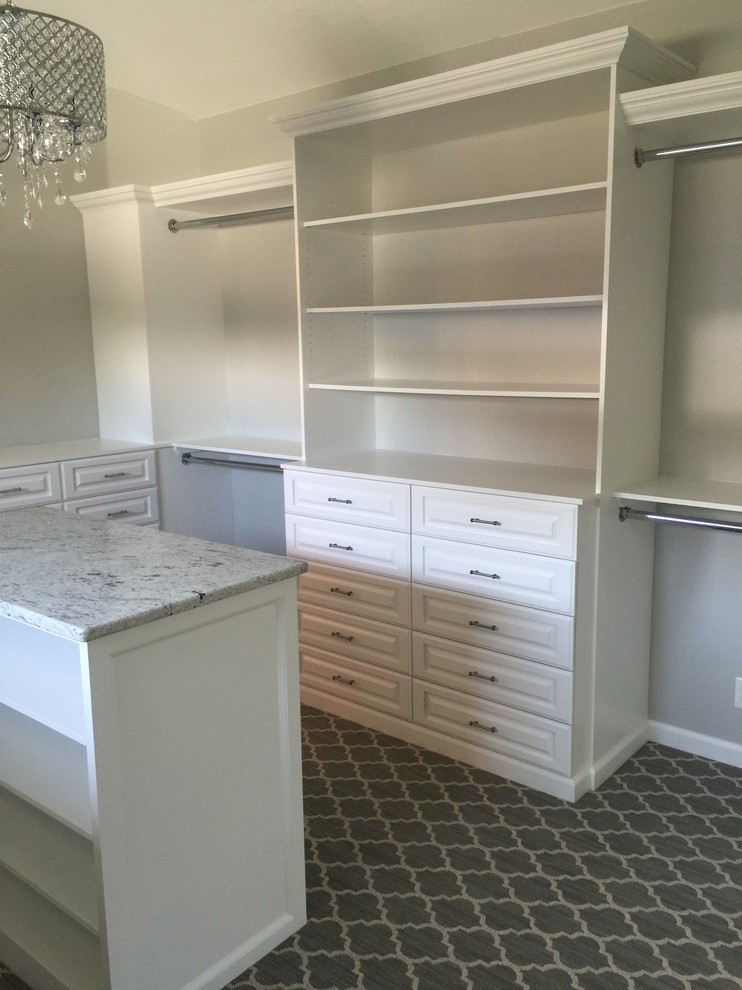 Large shabby-chic style walk-in wardrobe in Boise with raised-panel cabinets, white cabinets, carpet and grey floors.