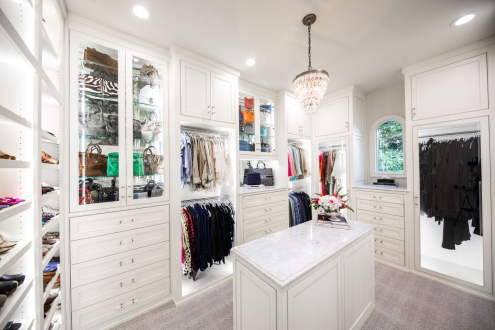 Photo of a large traditional walk-in wardrobe for women in Dallas with beaded cabinets, white cabinets, carpet and grey floors.