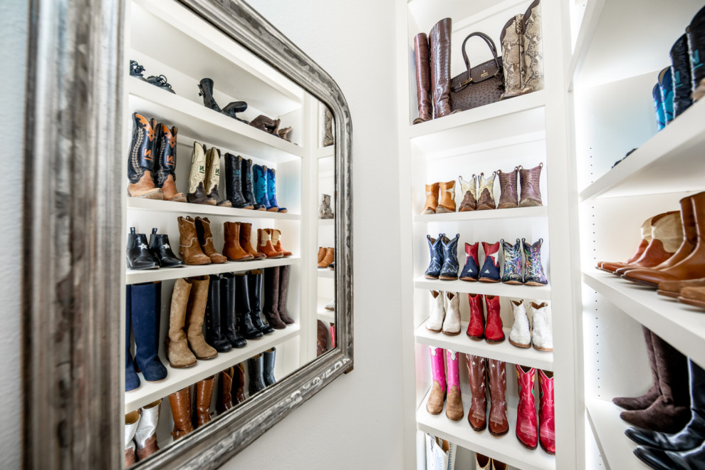 This is an example of a large traditional walk-in wardrobe for women in Dallas with beaded cabinets, white cabinets, carpet and beige floors.