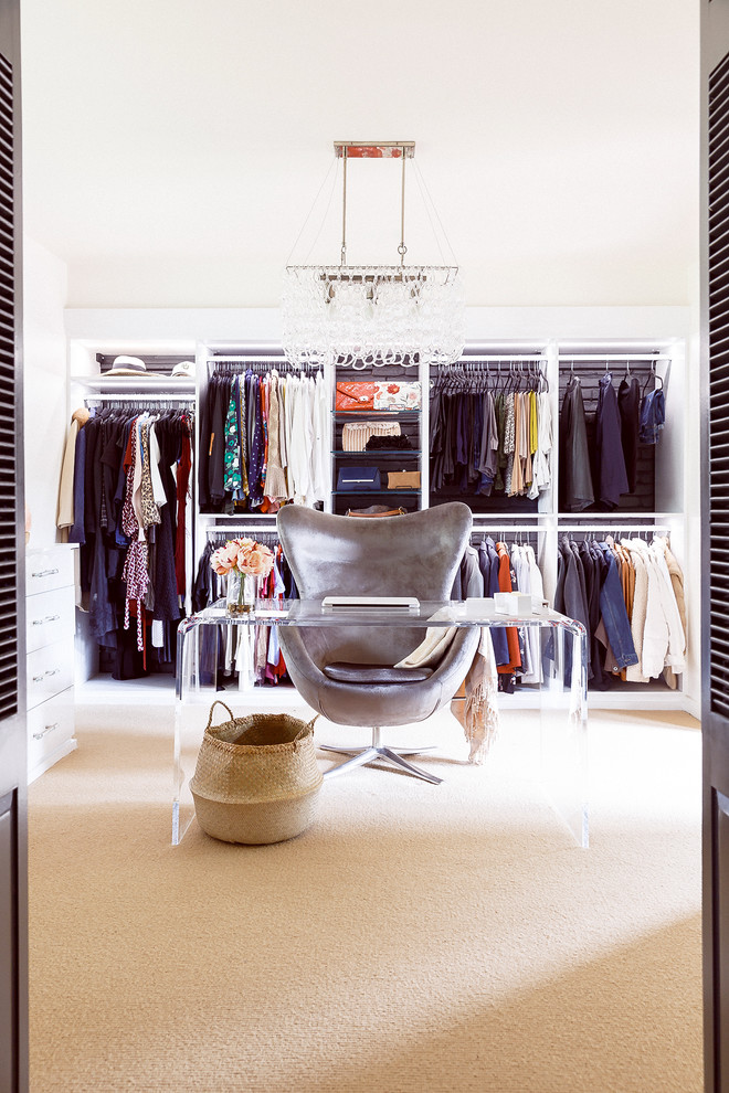 Inspiration for a large retro dressing room for women in Houston with open cabinets, white cabinets, carpet and beige floors.