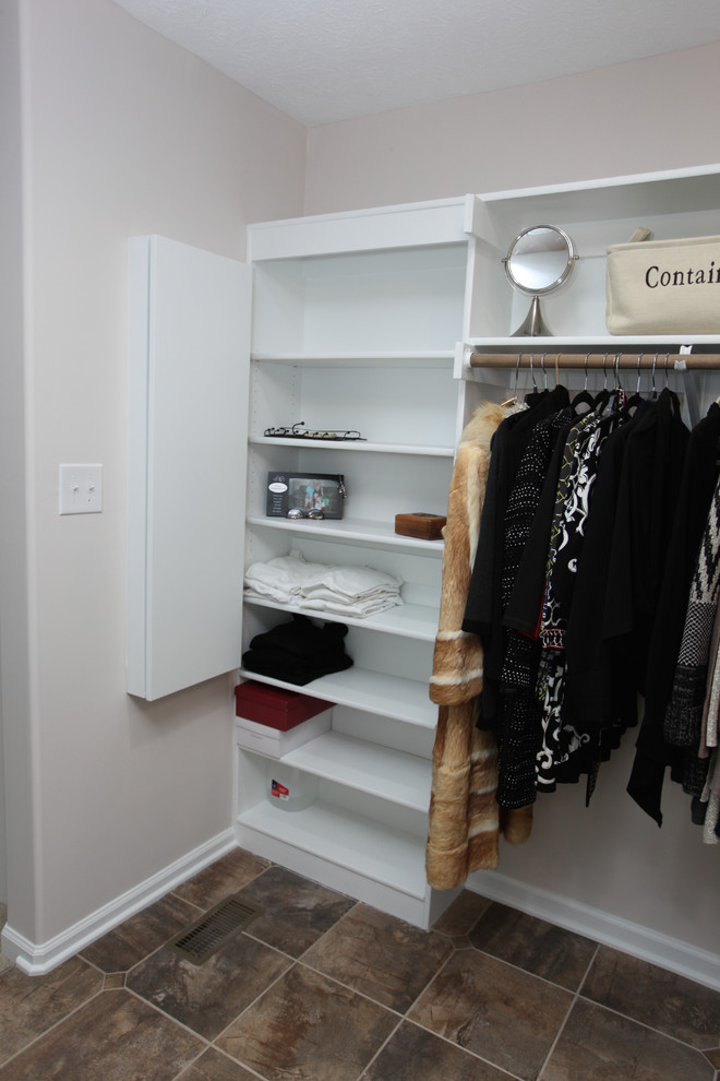 Example of a mid-sized classic gender-neutral slate floor and brown floor walk-in closet design in Indianapolis with raised-panel cabinets and white cabinets