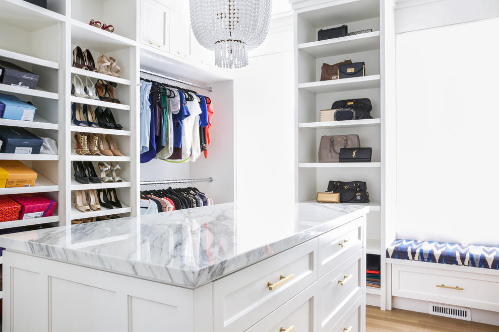 Exempel på ett stort klassiskt walk-in-closet för kvinnor, med skåp i shakerstil, vita skåp, ljust trägolv och brunt golv