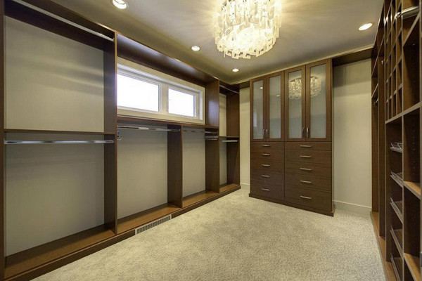 Large transitional gender-neutral carpeted and gray floor walk-in closet photo in Other with flat-panel cabinets and medium tone wood cabinets