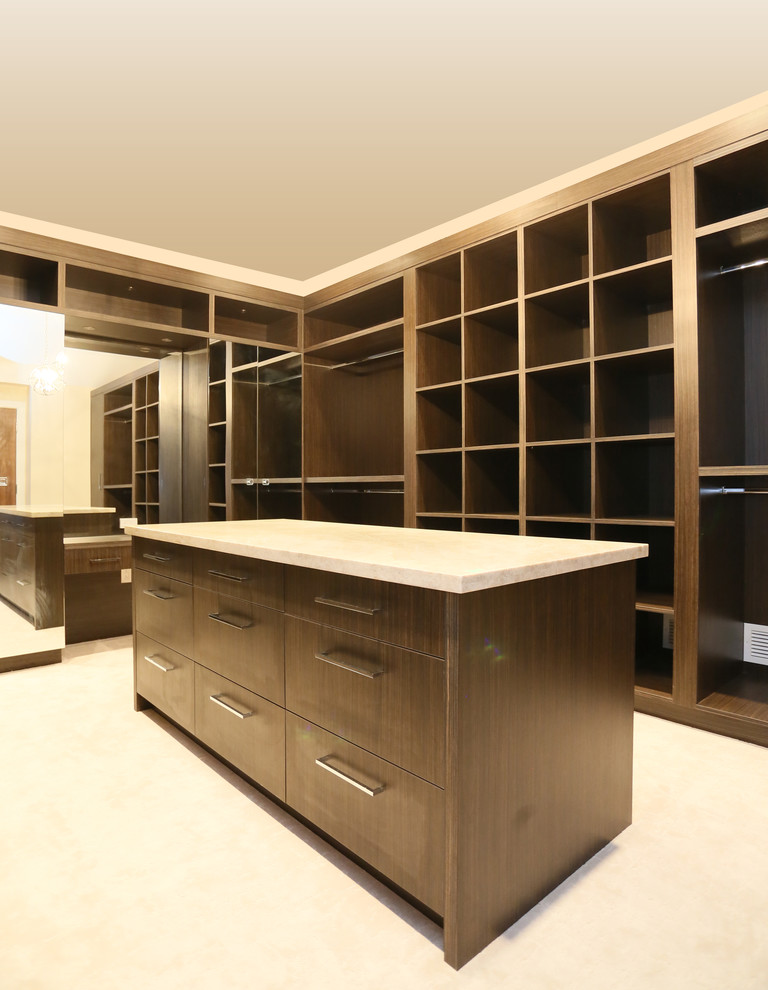 Design ideas for an expansive world-inspired walk-in wardrobe for men in Vancouver with open cabinets, dark wood cabinets and carpet.