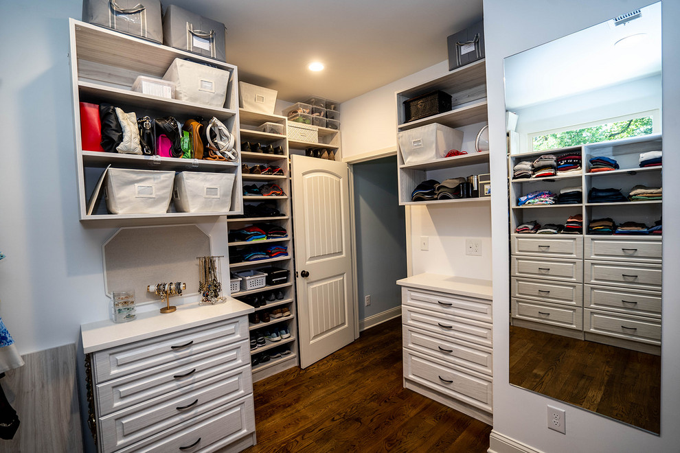 Inspiration for a medium sized contemporary gender neutral walk-in wardrobe in Atlanta with raised-panel cabinets, brown floors, light wood cabinets and medium hardwood flooring.