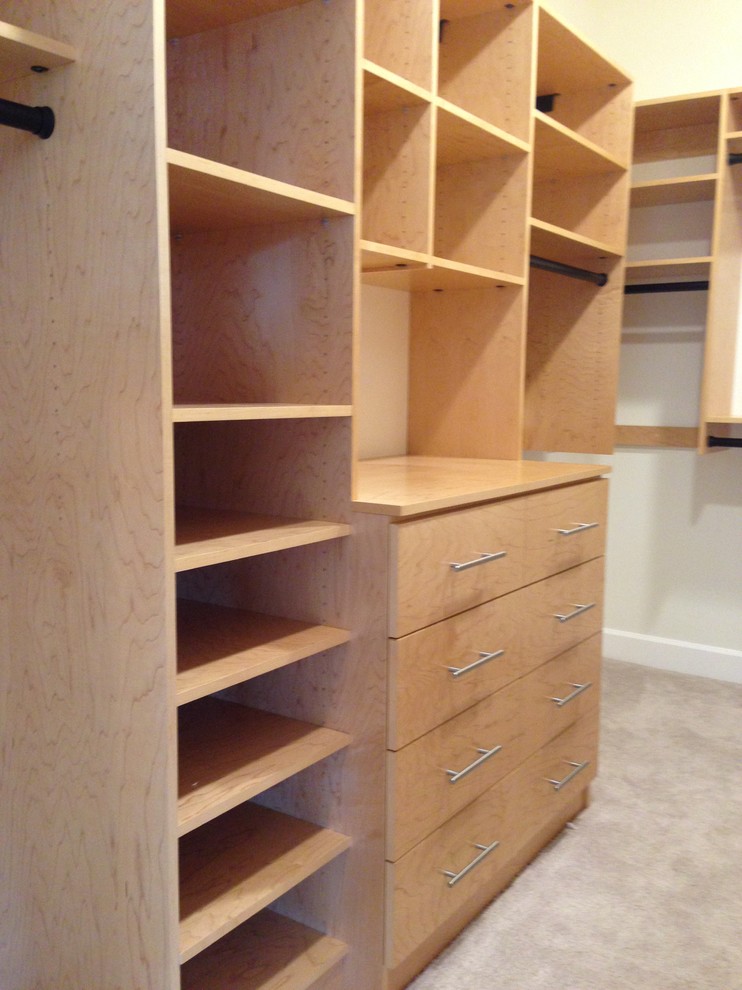 Medium sized contemporary walk-in wardrobe for men in Seattle with medium wood cabinets and carpet.