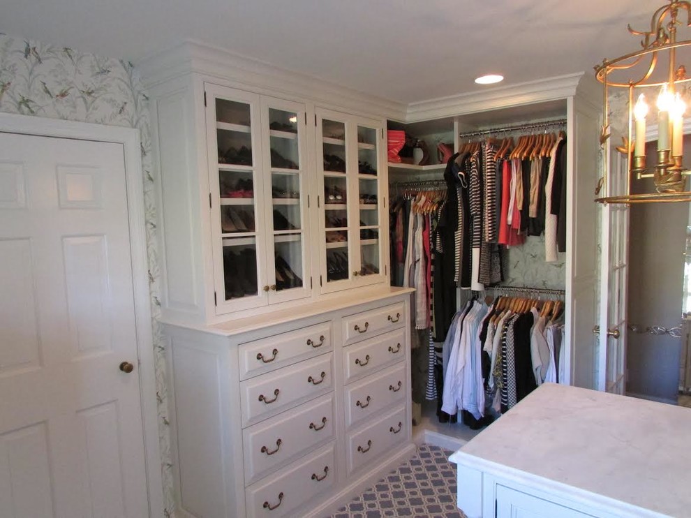 Example of a large classic gender-neutral dressing room design in Philadelphia with raised-panel cabinets and white cabinets