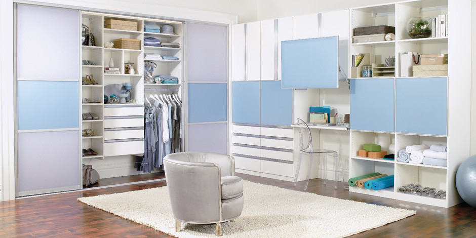 This is an example of a contemporary wardrobe in Hawaii with flat-panel cabinets and white cabinets.