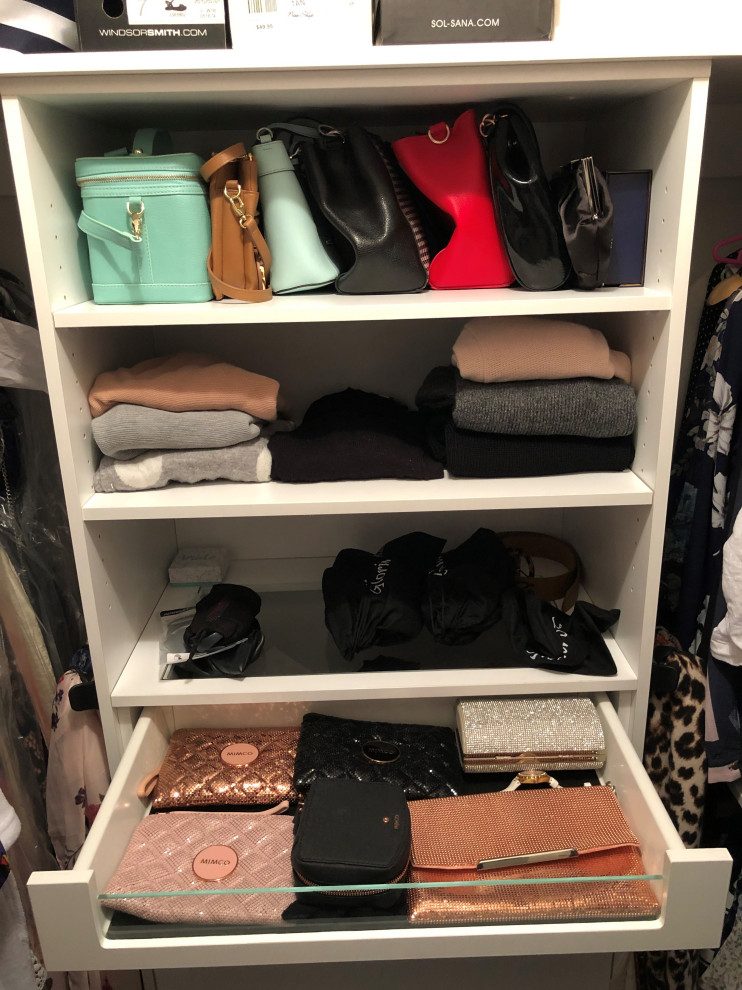 This is an example of a medium sized modern walk-in wardrobe for women in Newcastle - Maitland with open cabinets, white cabinets, carpet and black floors.