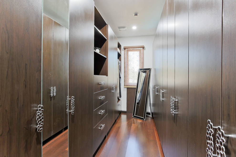 Inspiration for a small contemporary walk-in wardrobe in Toronto with flat-panel cabinets, dark wood cabinets and medium hardwood flooring.