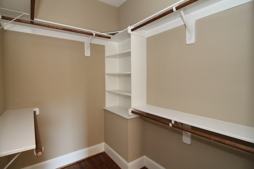 Example of a small arts and crafts gender-neutral medium tone wood floor walk-in closet design in Raleigh