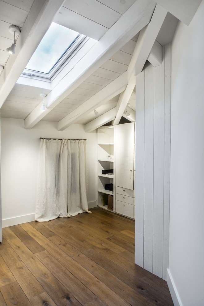 Inspiration for a medium sized country gender neutral walk-in wardrobe in Other with open cabinets, white cabinets and medium hardwood flooring.