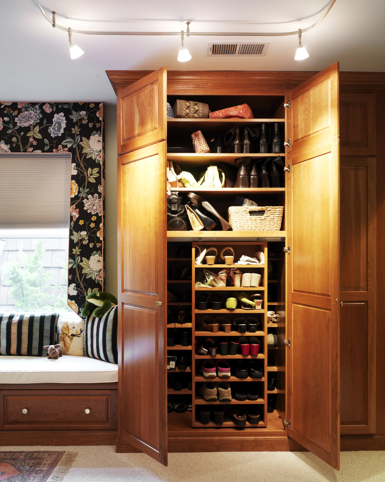 Reach-in closet - traditional reach-in closet idea in DC Metro with raised-panel cabinets and medium tone wood cabinets