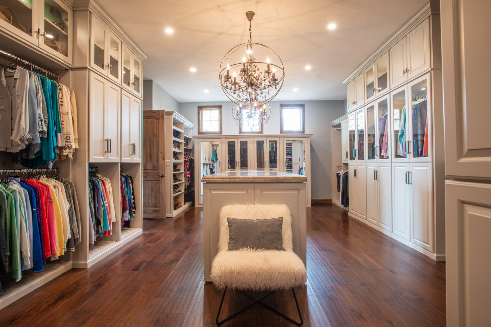 Large traditional gender neutral dressing room in Denver with raised-panel cabinets, grey cabinets, dark hardwood flooring, brown floors and a vaulted ceiling.