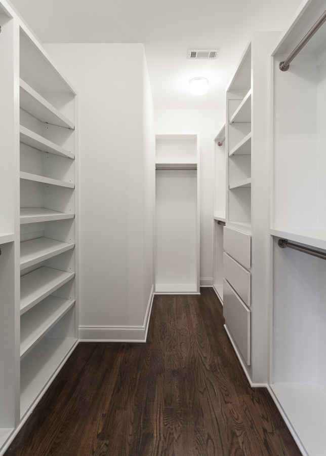 Medium sized classic walk-in wardrobe in Atlanta with open cabinets, white cabinets, dark hardwood flooring and brown floors.