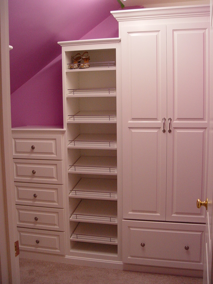 Classic walk-in wardrobe for women in Providence with white cabinets and carpet.