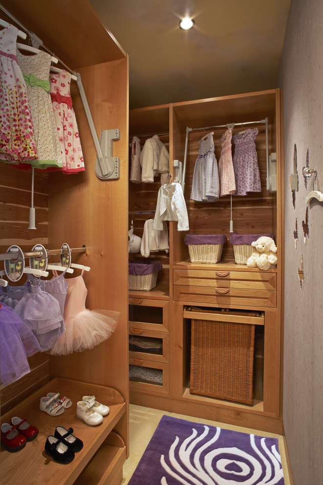 Example of a classic walk-in closet design in Los Angeles with open cabinets and medium tone wood cabinets