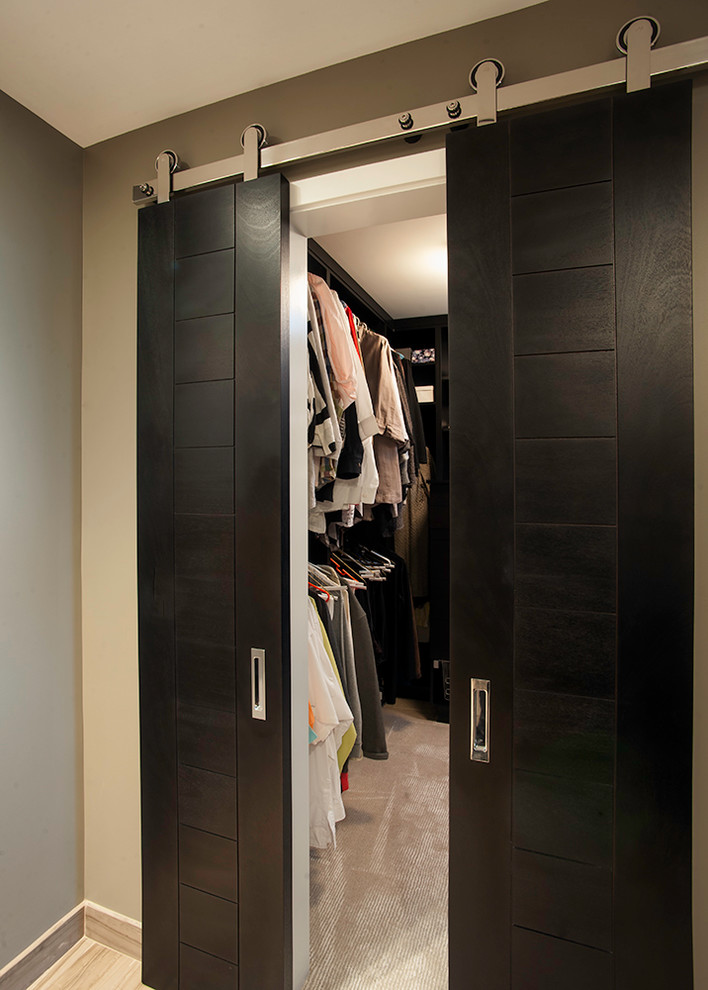 Small contemporary walk-in wardrobe in Cincinnati with open cabinets and dark wood cabinets.