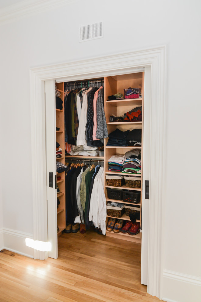 Walk-in closet - small transitional gender-neutral light wood floor and beige floor walk-in closet idea in Boston with open cabinets and light wood cabinets