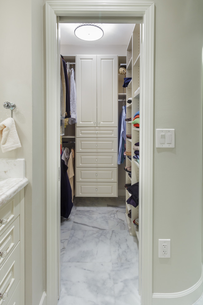 Photo of a medium sized classic walk-in wardrobe for men in Miami with raised-panel cabinets, white cabinets and marble flooring.