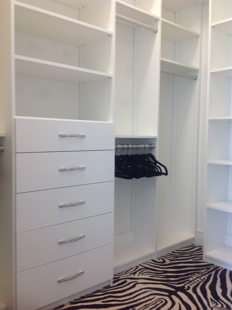 Photo of a contemporary wardrobe in Miami with flat-panel cabinets and white cabinets.