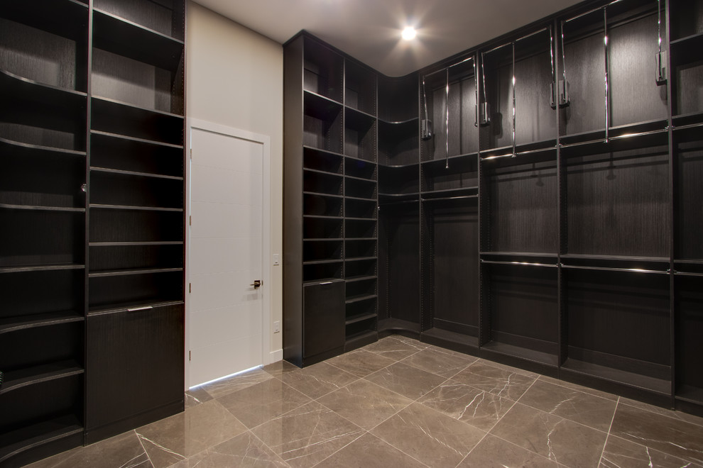 Walk-in closet - large contemporary walk-in closet idea in Las Vegas with flat-panel cabinets and black cabinets
