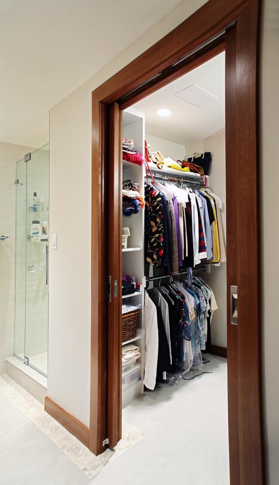 This is an example of a medium sized contemporary gender neutral walk-in wardrobe in DC Metro with open cabinets, white cabinets and ceramic flooring.