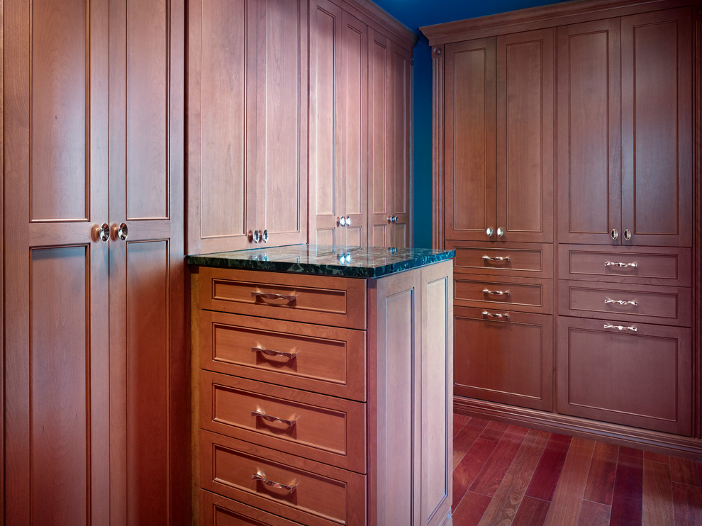 Inspiration for a large timeless gender-neutral medium tone wood floor and brown floor dressing room remodel in Denver with recessed-panel cabinets