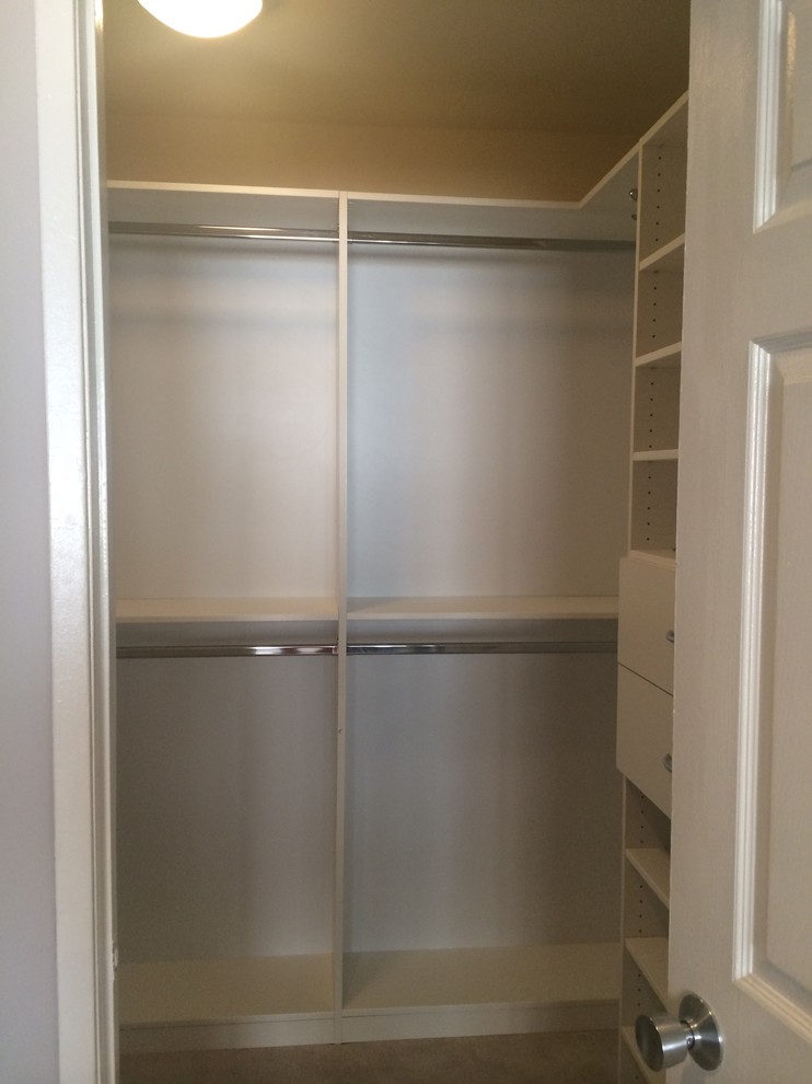 Photo of a small gender neutral standard wardrobe in Los Angeles with flat-panel cabinets, white cabinets and carpet.