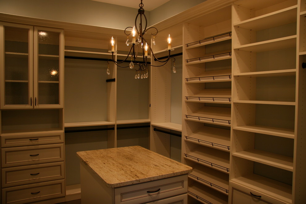 Example of a large classic gender-neutral walk-in closet design in Jacksonville with beige cabinets