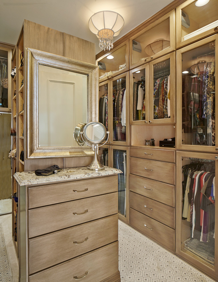 Traditional dressing room in Dallas with medium wood cabinets.