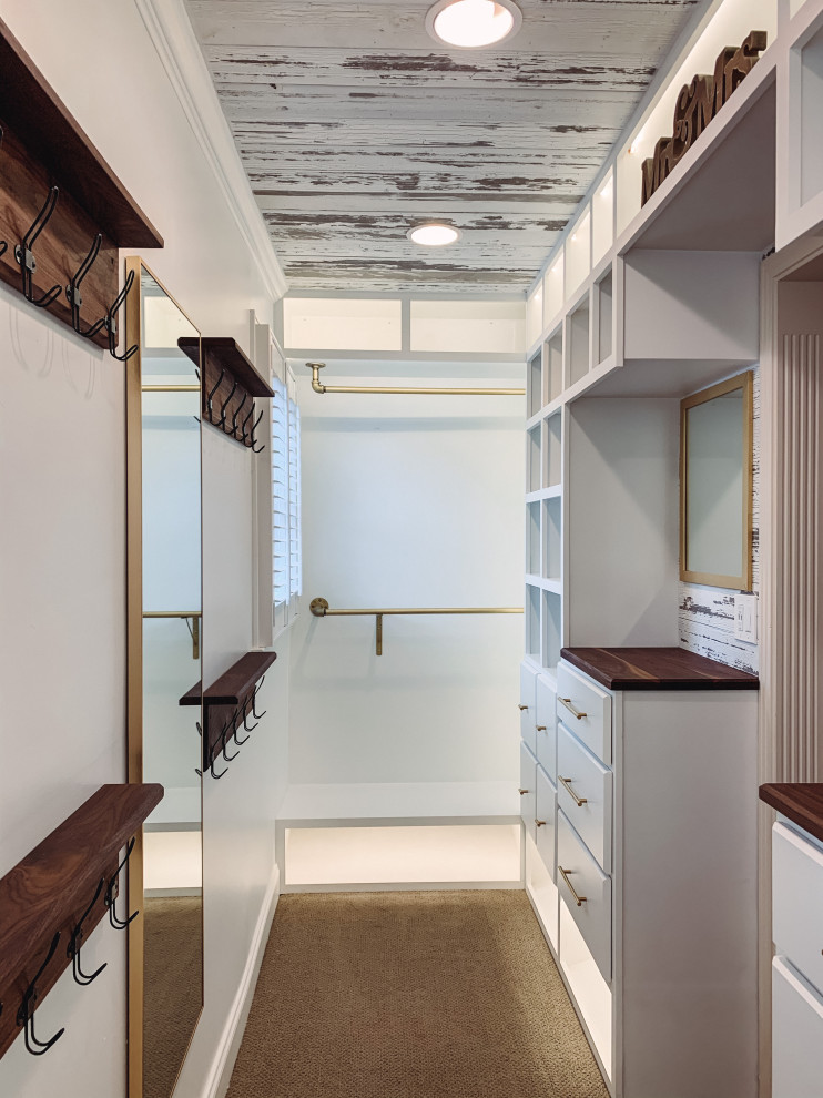 Пример оригинального дизайна: встроенный шкаф среднего размера, унисекс в стиле кантри с фасадами с выступающей филенкой, белыми фасадами, ковровым покрытием, бежевым полом и деревянным потолком
