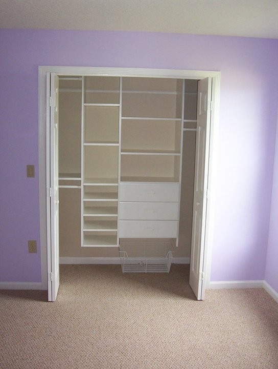 This is an example of a medium sized classic standard wardrobe for women in Jacksonville with open cabinets, white cabinets, carpet and beige floors.