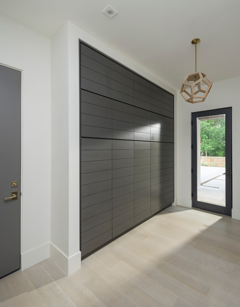 Large trendy gender-neutral light wood floor dressing room photo in Salt Lake City with flat-panel cabinets and black cabinets