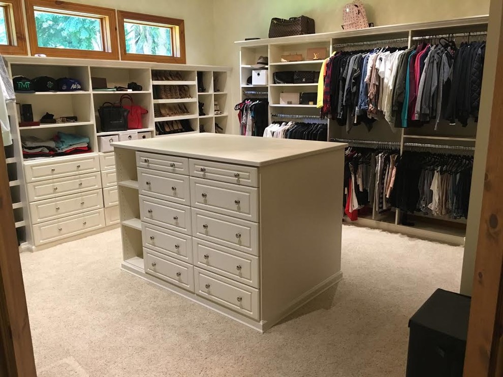 Inspiration for a large contemporary gender neutral walk-in wardrobe in Seattle with recessed-panel cabinets, white cabinets, carpet and beige floors.