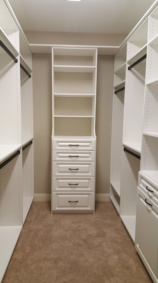 Medium sized contemporary gender neutral walk-in wardrobe in Other with raised-panel cabinets and white cabinets.