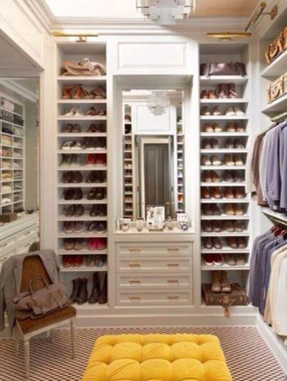 Walk-in closet - mid-sized traditional gender-neutral carpeted walk-in closet idea in Miami with open cabinets and white cabinets