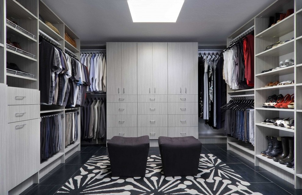 Inspiration for a mid-sized modern gender-neutral porcelain tile and black floor walk-in closet remodel in Calgary with flat-panel cabinets and gray cabinets