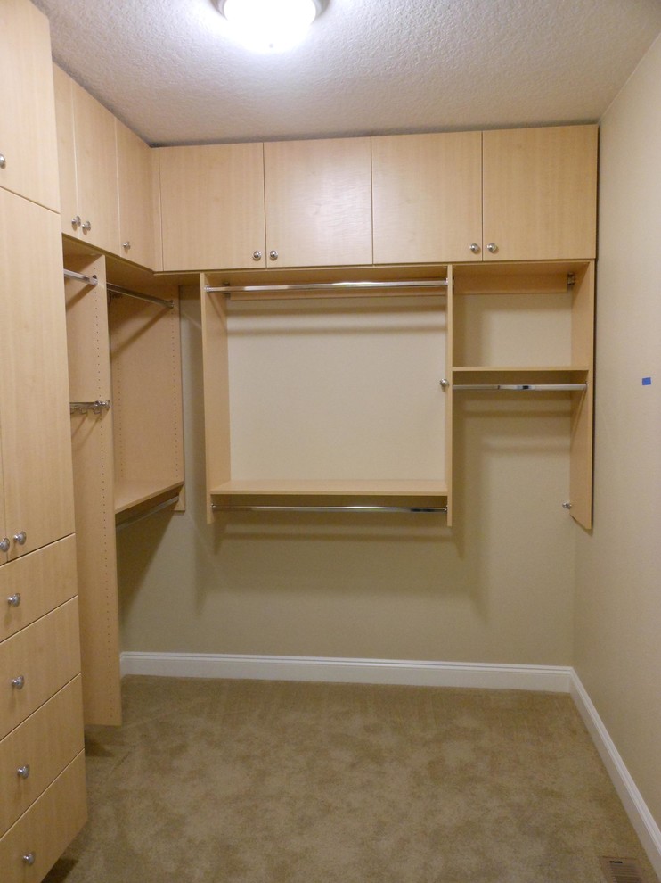 Inspiration for a large contemporary gender neutral walk-in wardrobe in Portland with flat-panel cabinets and light wood cabinets.