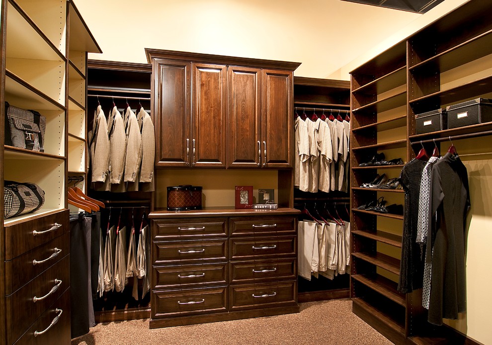 Inspiration for a medium sized traditional gender neutral walk-in wardrobe in Phoenix with raised-panel cabinets, dark wood cabinets and carpet.