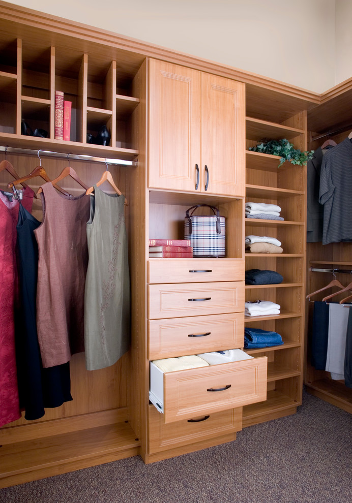 Walk-in closet - mid-sized traditional gender-neutral carpeted walk-in closet idea in Phoenix with recessed-panel cabinets and light wood cabinets